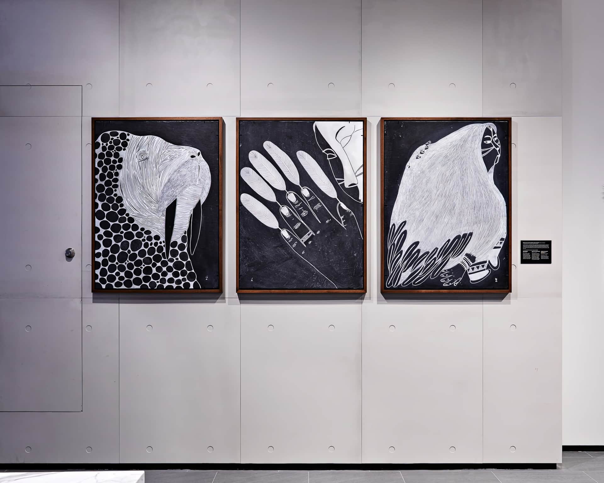 Ningiukulu Teevee, Decorated Walrus, Hand With Feathers, Figure with Hair Turning into Feathers, 2018, installed at Canada Goose, Montréal, Canada